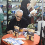 Author-signing-and-dedicating-his-book-to-readers-at-the-International-Book-Fair-Algiers-Algeria