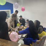 Birthday cake being cut during Nadjib from Elite d'Or birthday celebration party at the academy