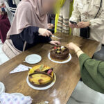 Elite d'Or English teacher Roumaissa cutting her birthday cake during her celebration party at the academy