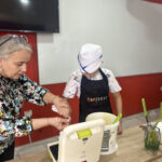 Elite d'Or French teacher and student holding homemade pancake after a fun cooking vocabulary lesson Dellys Algeria