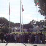 Elite-dOr-administration-Nadjib-students-and-parents-group-photo-at-the-International-Book-Fair-with-flags-of-nations-in-the-background-Algiers-Algeria-2