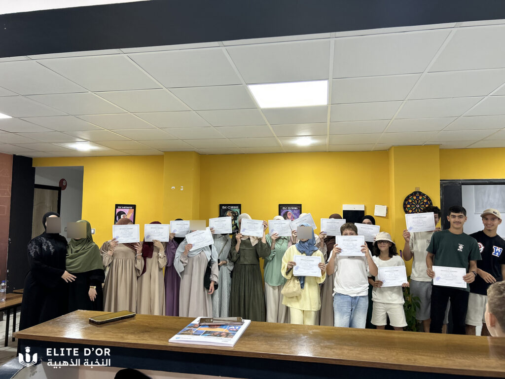 Elite d'Or adult English class students group photo receiving their certificates with teacher Roumaissa and Najat during end of course ceremony Dellys Algeria