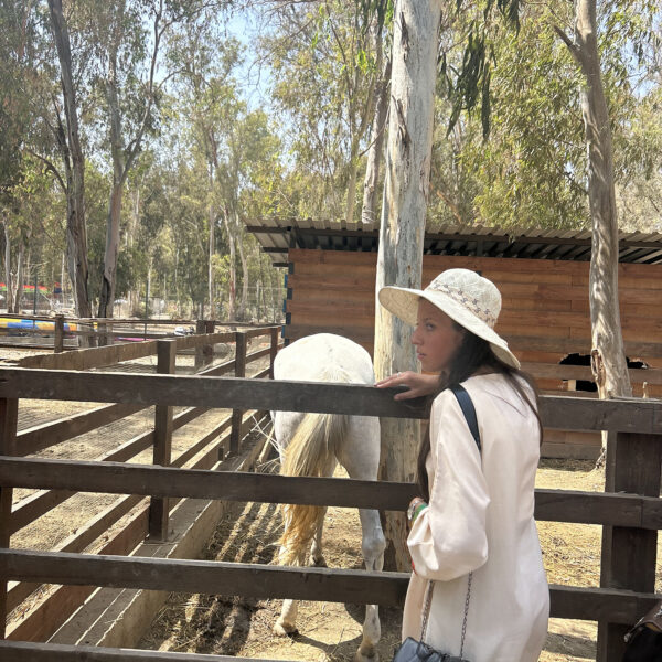 Elite d'Or student Nariman taking a souvenir photo with a horse at the Tipaza zoo Algeria