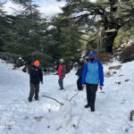Elite d'Or students climbing the snowy Tikjda mountain peak during the winter trip Algeria