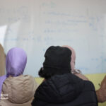Elite-dOr-students-inside-the-classroom-with-teacher-writing-on-the-whiteboard-during-a-lesson