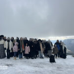 Elite d'Or students parents and administration group photo during the Tikjda winter mountain trip Algeria