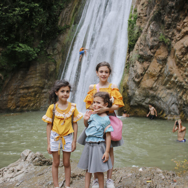 Elite-dOr-students-posing-with-the-waterfall-during-the-nature-trip-to-Kfrida-Algeria