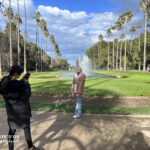 Elite d'Or two students taking photos of each other inside Jardin d'Essai botanical garden Algiers Algeria
