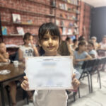 Elite d'Or young student smiling proudly holding his certificate from the language program Dellys Algeria (2)